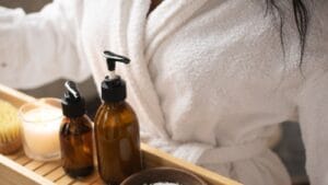 Black woman holding skincare products while considering what to use