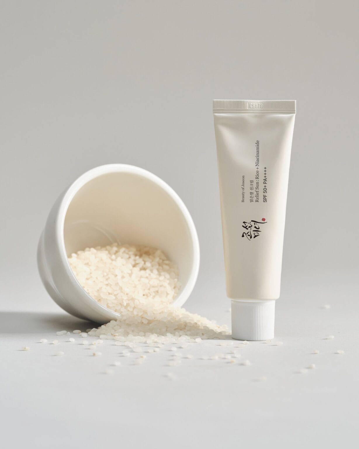 Beauty of Joseon Relief Sun Rice + Niacinamide SPF50+ PA++++ 50 ml sunscreen tube standing beside rice