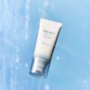 SKIN1004 Hyalu-Cica Water-Fit Sun Serum SPF50+ PA++++ 50 ml tube on a blue background