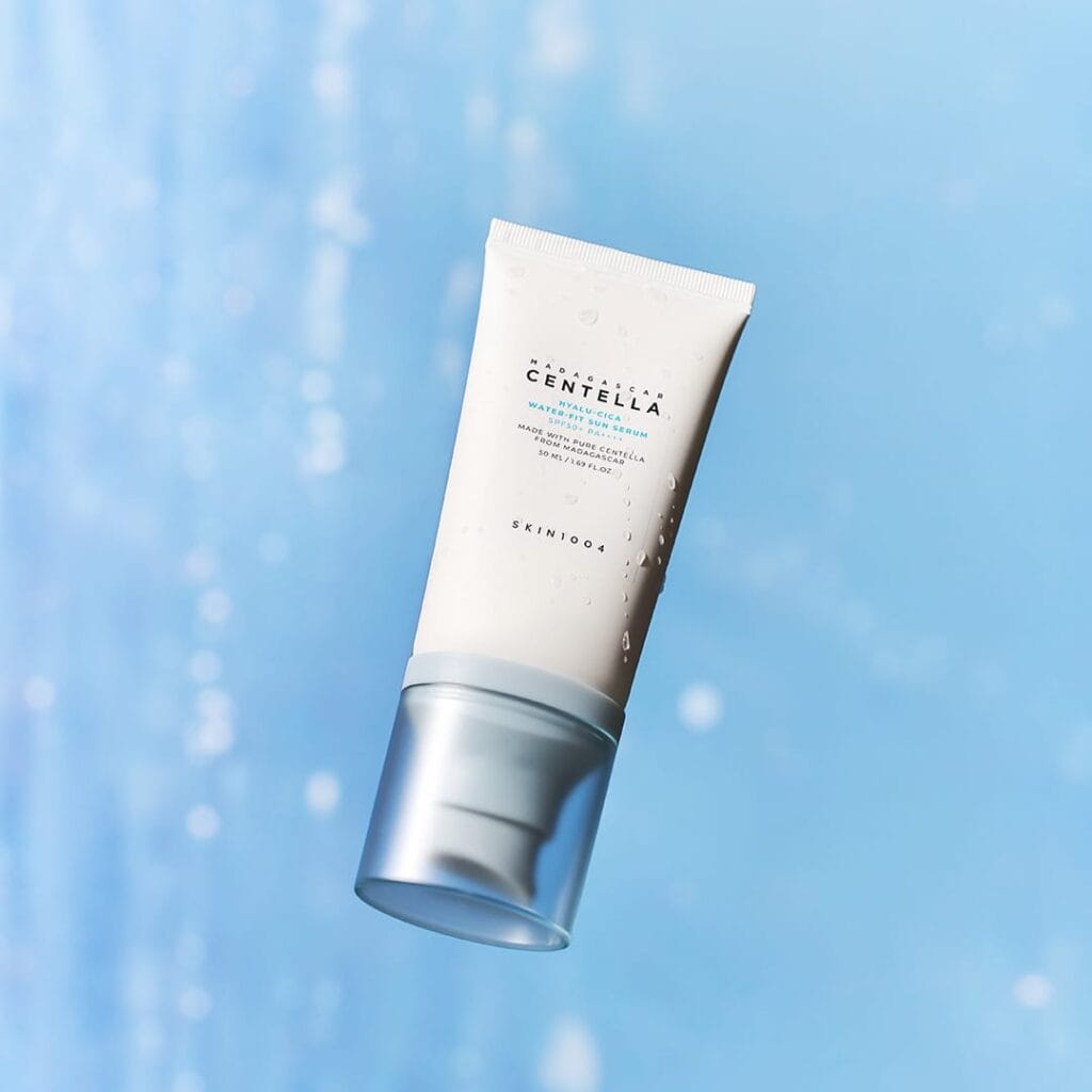 SKIN1004 Hyalu-Cica Water-Fit Sun Serum SPF50+ PA++++ 50 ml tube on a blue background