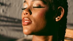 African woman outdoors in bright sunlight with a natural skin finish