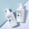 Two APLB Tranexamic Acid Niacinamide Body Lotion 300 ml pump bottles on a blue background