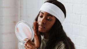 Black woman applying moisturizer during a simple skin barrier support routine