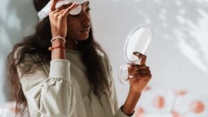 Black woman gently cleansing her face during an evening double cleansing routine
