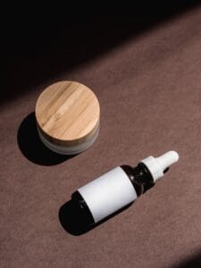Unbranded serum dropper bottle and moisturizer jar for a simple retinol skincare routine