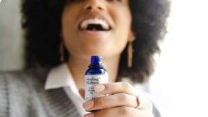 Black woman reviewing a skincare bottle before use